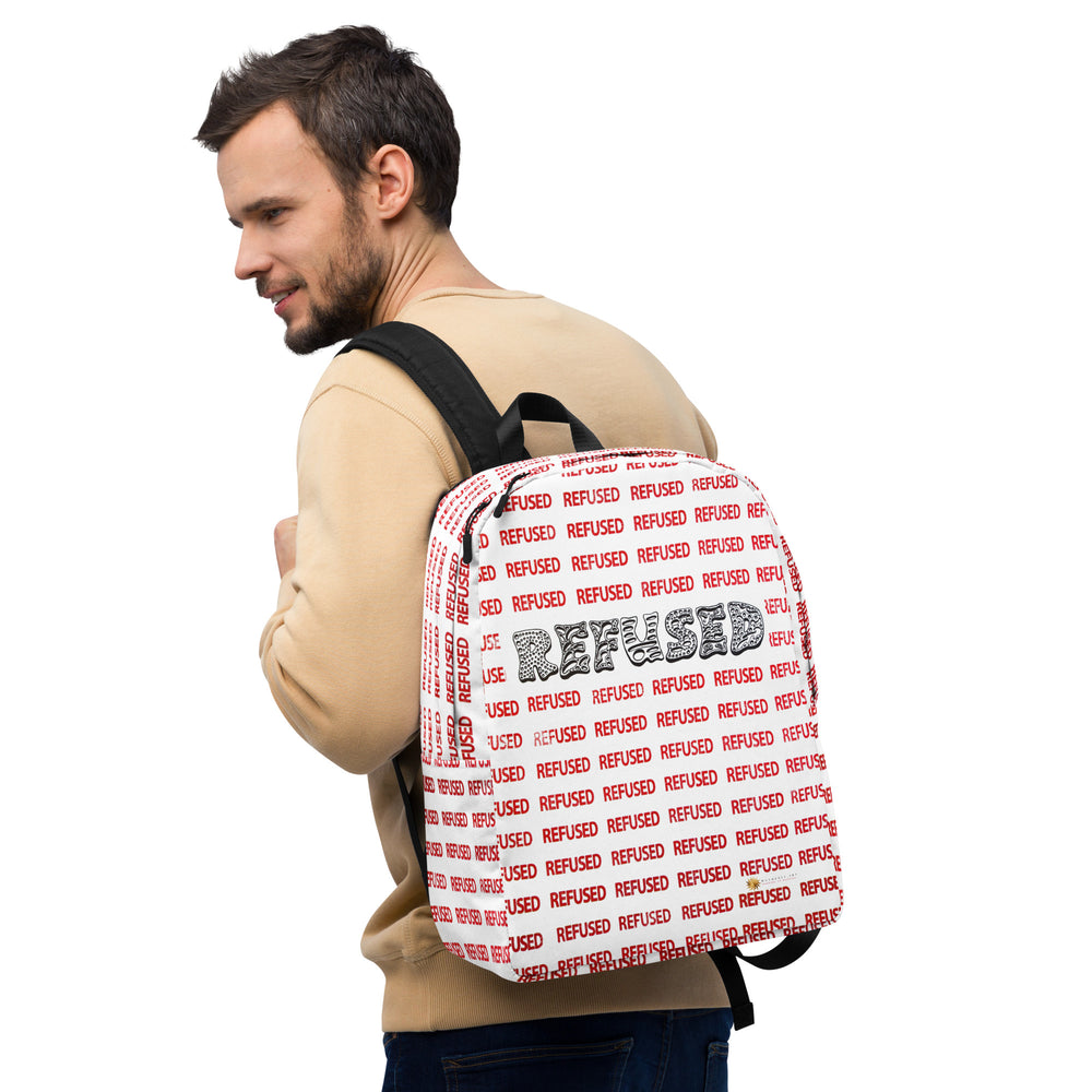 Lifestyle image of a white man wearing a white backpack with red lettering and black wordmark REFUSED, right-front angle on model wearing the Refused backpack—bold all-over “REFUSED” print and centered black wordmark; padded shoulder straps shown for comfortable everyday use.