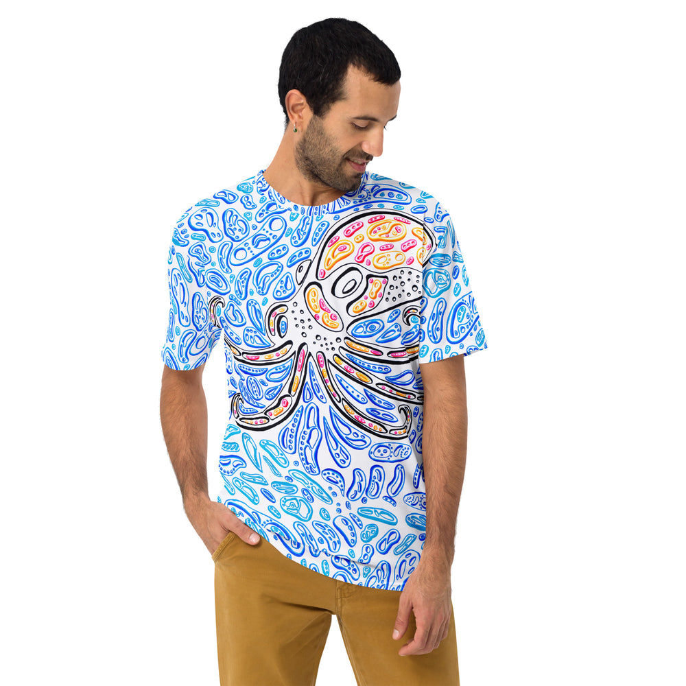 A male model facing forward wearing “The Octopus” crew-neck t-shirt, with the bold octopus graphic centered across the chest.  There are blue shapes and the octopus is red and orange.  Nicholas Hayes Art.
