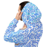 a man pulling up the hood to his blue hoodie sweatshirt with blue shapes.  optical illusion camouflage. op art design by Nicholas Hayes.