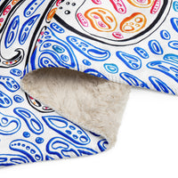 a folded fleece blanket with a painting of an octopus.  light blue shapes and dark blue shapes making the effect look like water.  white background.  octopus art.  ocean art.  optical art by Nicholas Hayes.  Op art.