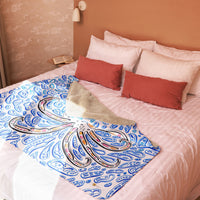 an octopus blanket folded on a bed.  The octopus is orange with red and black highlights.  The shapes make an optical illusion of an octopus.  Ocean art.  Nautical artworks.  Art by Nicholas Hayes artist. op art.