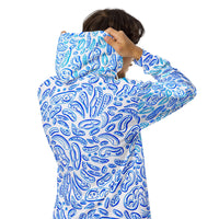a man putting on a blue and white hoodie.  blue shapes make designs. optical illusion clothing by Nicholas Hayes