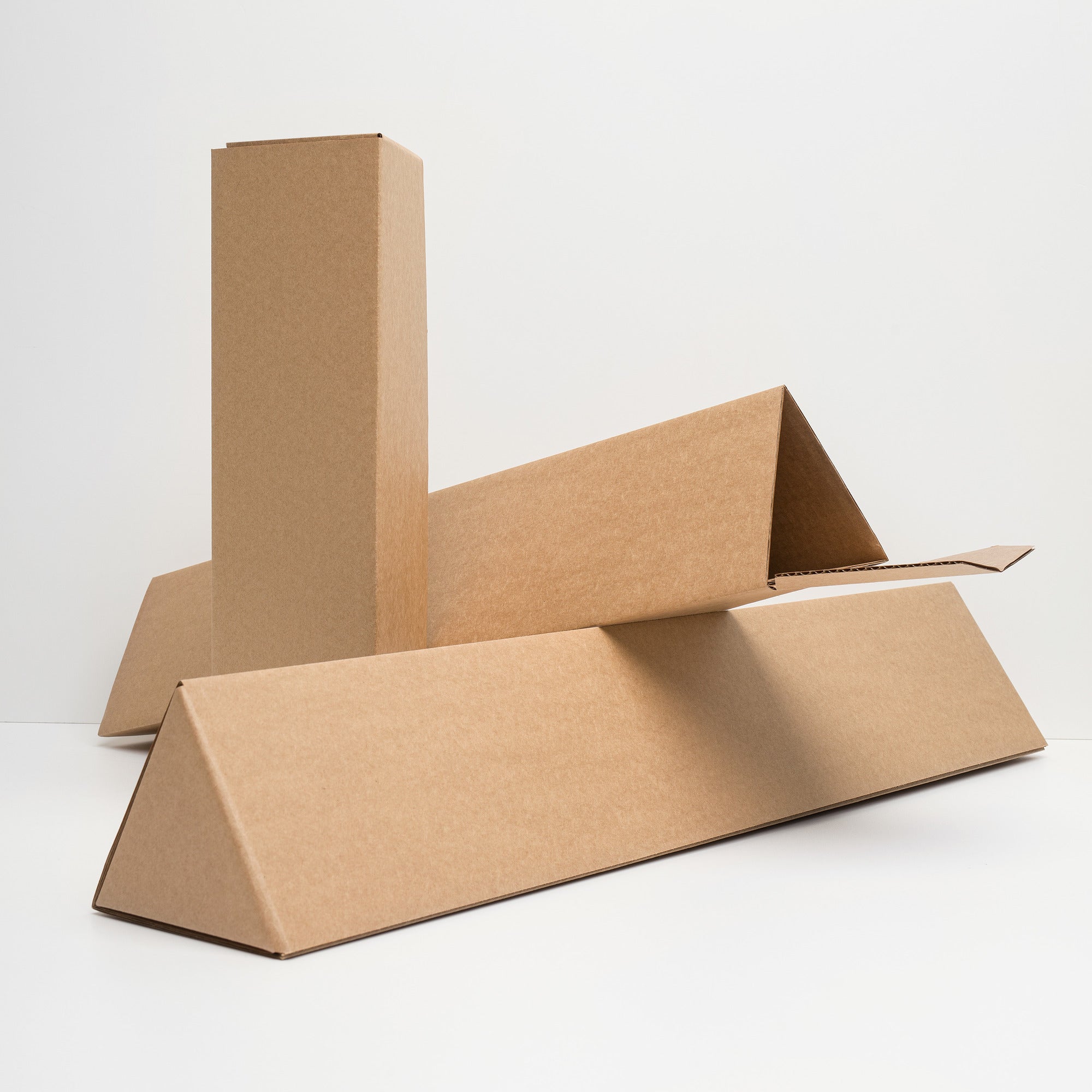 Triangular kraft poster tubes used to ship the ‘Penumbra Painting No. 1’ fine art print—sturdy, crush-resistant packaging keeps the 12×16 museum-quality matte paper safe during delivery. Free shipping for US shoppers. Nicholas Hayes Art, LLC.