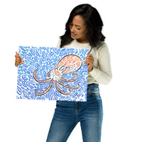 Model holding “The Octopus” 12×16 fine art print by Nicholas Hayes, showing real-life scale; psychedelic octopus graphic with blue cellular patterns, crisp edges, and gallery-ready finish for modern ocean-themed wall décor.